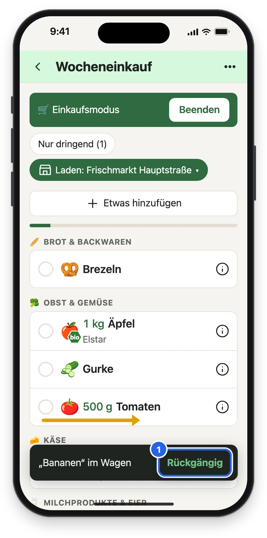 Bananen und Vollkornbrot sind im Wagen, unten die Meldung mit Rückgängig, ein Pfeil zeigt das Wischen bei den Tomaten
